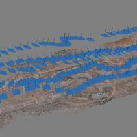 Fig. 3. Data processing in Photoscan of one of the flights. Camera (blue rectangles) position/orientation reconstruction and features extraction (sparse colored cloud) through SFM algorithms. The result of the photogrammetric process allows to see the path of the cameras, performed during the acquisition, reconstructed in the virtual environment.